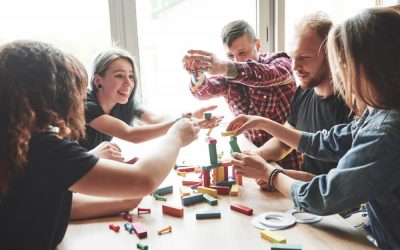 group-of-creative-friends-sitting-on-wooden-table-people-were-having-fun-while-playing-board-game (1)